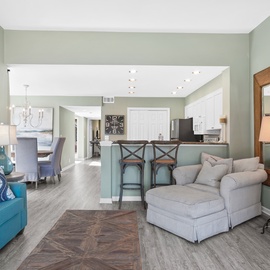 Sink into coastal comfort in your spacious living area, where soft furnishings and soothing colors create the perfect retreat for relaxation.