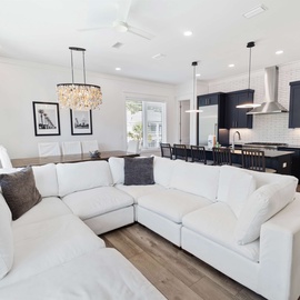 Sink into plush seating in your open-concept living space, where modern elegance meets comfort with gleaming countertops and stylish lighting throughout.