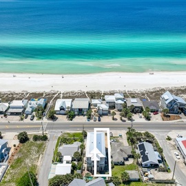 Stunning beachfront location with pristine white sand and turquoise waters just steps from the property entrance.