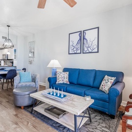 Sink into this vibrant blue sofa and feel the coastal vibes surround you in this thoughtfully designed open living space.