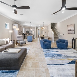 Relax in your spacious open-concept living area with plush seating, modern kitchen, and coastal-inspired décor creating the perfect gathering space.