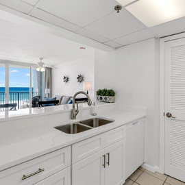 Your bright kitchen opens to stunning ocean views, where you'll love preparing meals while watching waves dance beyond your private balcony.