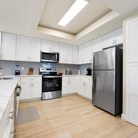 Your spacious kitchen features modern white cabinetry, stainless steel appliances, and everything you need to create memorable meals during your stay.