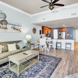 Relax in your bright open-concept space where coastal charm meets modern comfort, complete with ceiling fan and fully equipped kitchen.