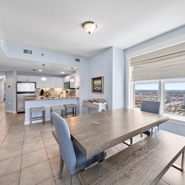 Gather around your dining table with city views stretching beyond the window, while the open kitchen invites easy meal prep and conversation.