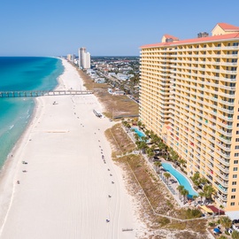 Stunning beachfront property offering direct access to pristine white sand and turquoise waters, perfectly positioned along the Gulf Coast shoreline.