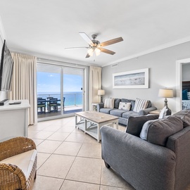 Unwind in your spacious living room with plush seating and stunning ocean views through floor-to-ceiling windows.