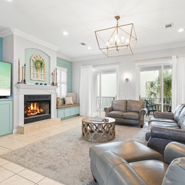 Unwind in your elegant living room with, plush leather seating, and serene coastal views through French doors.