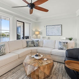 Sink into your plush sectional sofa while cool ceiling fan breezes and natural light create the perfect relaxation haven.