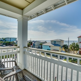 Relax on your private balcony with panoramic views of the coastal community and glimpses of the ocean beyond.