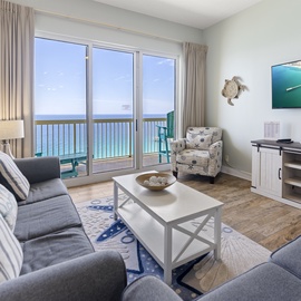 Unwind in your oceanfront living room where floor-to-ceiling windows frame endless sea views and plush seating invites relaxation.