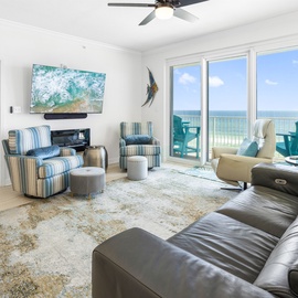 Your oceanfront living room awaits with plush seating, coastal décor, and stunning sea views through expansive windows.