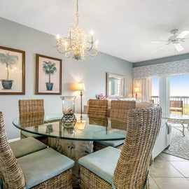 Gather around your elegant dining table while enjoying ocean views through sliding glass doors that lead to your private balcony retreat.