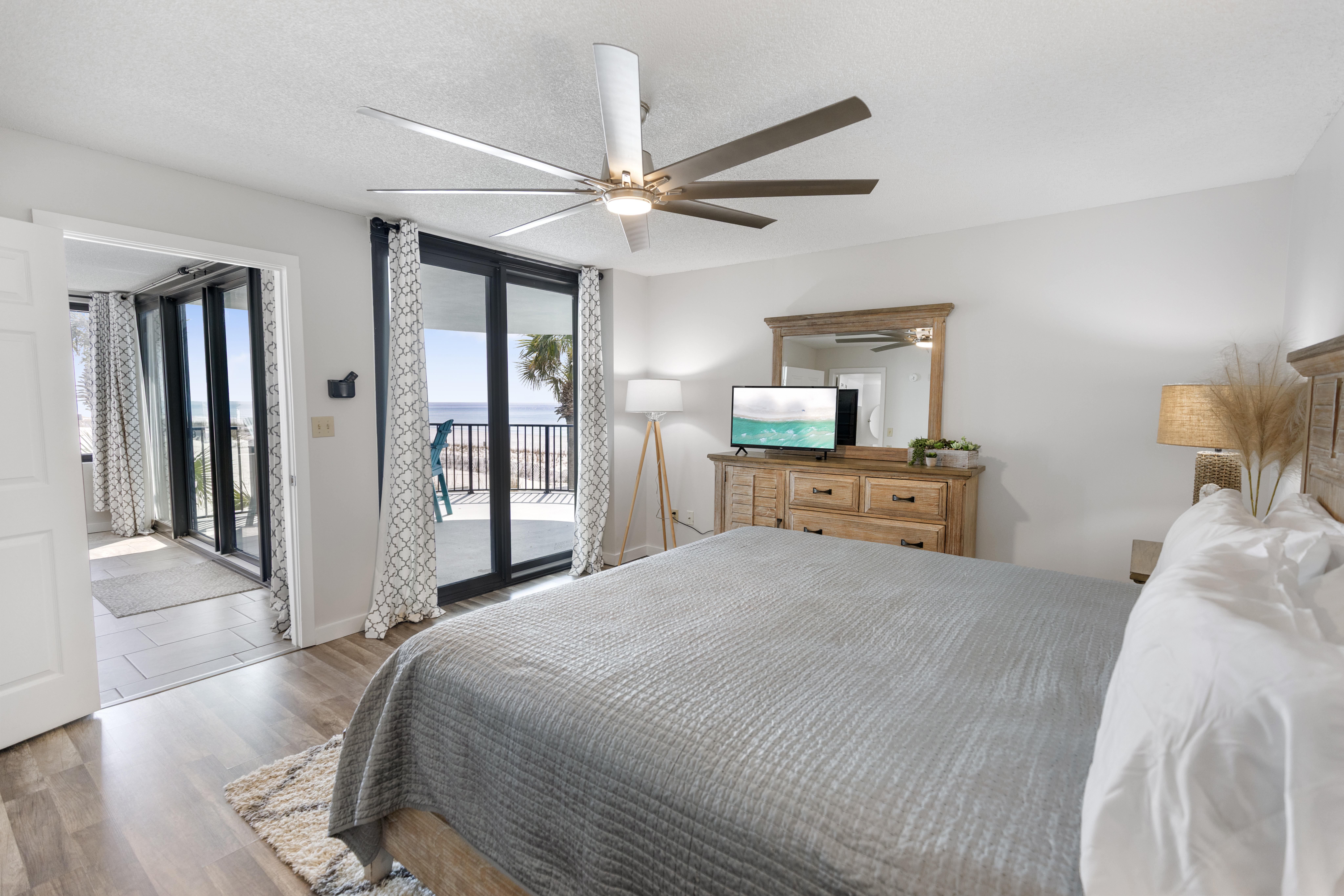 Wake up to ocean breezes and natural light in your coastal bedroom, where soft linens and warm wood furnishings create the perfect sanctuary.