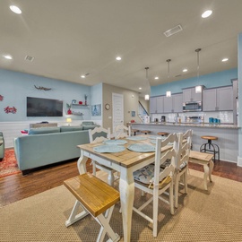 Relax in your open-concept living space with coastal charm. Enjoy the fully equipped kitchen, comfortable seating, and beach-themed decor that makes you feel instantly at home.