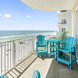 Step onto your private balcony with turquoise chairs and sip morning coffee while watching waves roll onto pristine white sand below.