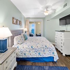 Relax in your serene bedroom with soft coastal colors and ocean views from your private balcony.