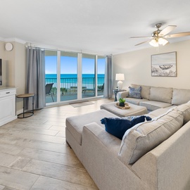Sink into your spacious sectional and watch the turquoise waves through floor-to-ceiling windows—your oceanfront living room awaits.