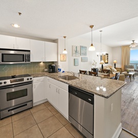 Your fully equipped kitchen opens to a bright living space with stunning ocean views from your private balcony.