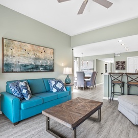Your bright, open living space features coastal decor and comfortable seating, perfect for relaxing after beach adventures.