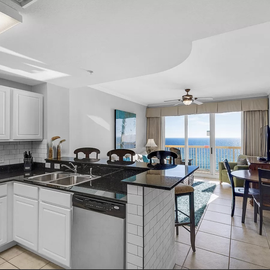Your fully equipped kitchen opens to breathtaking ocean views, perfect for morning coffee while watching the sunrise over endless blue waters.