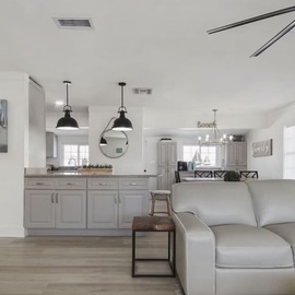 Relax in your open-concept living space where modern comfort meets coastal charm, complete with a fully-equipped kitchen for your culinary adventures.
