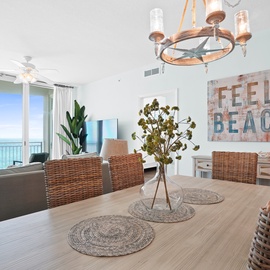 Your beachy dining room opens to stunning ocean views through floor-to-ceiling windows, perfect for morning coffee or sunset dinners.