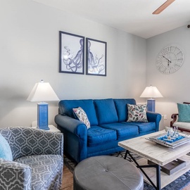 Sink into the coastal-inspired living room where ocean blues meet modern comfort, perfect for unwinding after beach days.