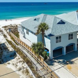 Stunning beachfront property featuring pristine white sand beaches and crystal-clear turquoise waters in a tropical paradise setting.