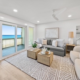 Relax in your bright coastal living space with ocean views and a private balcony just steps away from your comfortable seating area.