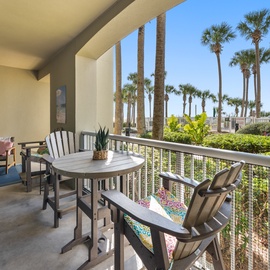 Relax on your private balcony with tropical palm views. Enjoy morning coffee at the outdoor dining table while soaking in the sunshine.