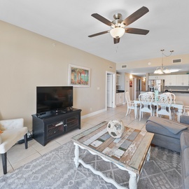 Relax in your spacious open-concept living space with comfortable seating, modern amenities, and a breezy ceiling fan overhead.