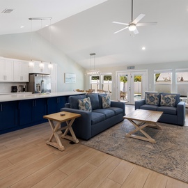 Unwind in your spacious open-concept living area where modern comfort meets coastal charm, perfect for gathering with loved ones.