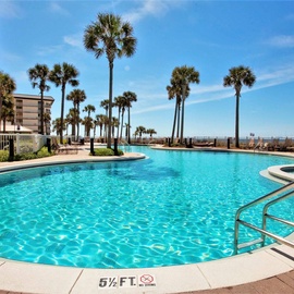 Dive into crystal-clear waters surrounded by swaying palms and endless blue skies in this tropical paradise pool area.
