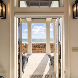 Step through elegant French doors to your private oceanfront terrace, where panoramic sea views and gentle ocean breezes await your arrival.