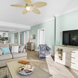 Sink into your spacious living room with soft coastal colors and comfortable seating, perfect for relaxing after beach days.