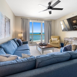 Sink into plush seating while ocean breezes flow through your private balcony doors, creating the perfect coastal retreat.