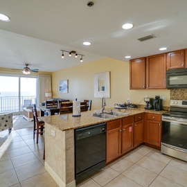 Cook and entertain effortlessly in your spacious open kitchen, complete with granite counters, stainless appliances, and stunning ocean views.