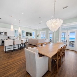 Stunning open-concept space where you'll gather for memorable meals while enjoying ocean views through floor-to-ceiling windows.