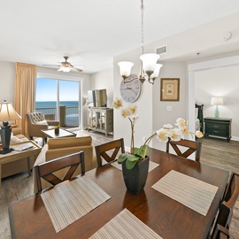 Unwind in your open-concept living space where warm wood tones meet breathtaking ocean views through floor-to-ceiling windows.
