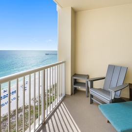 Relax on your private balcony with stunning ocean views and comfortable seating overlooking pristine white sand beaches.