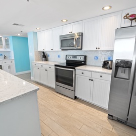 Your bright, modern kitchen features stainless steel appliances and spacious counters for preparing delicious meals during your stay.