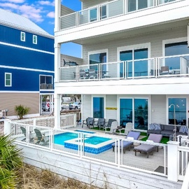 Modern beachfront property featuring private pool and multiple levels of outdoor space in a vibrant coastal neighborhood.