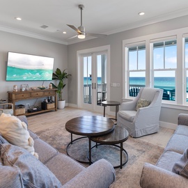 Sink into plush seating and enjoy stunning ocean views through floor-to-ceiling windows in your beautifully appointed living space.