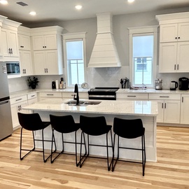 Your fully-equipped gourmet kitchen features marble countertops, stainless steel appliances, and an island with seating for four—perfect for culinary adventures.