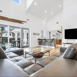 Sink into plush leather seating while enjoying your favorite shows on the mounted flat-screen TV in this bright, open living space.