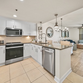 Your fully equipped kitchen flows seamlessly into the living space, perfect for preparing meals while staying connected with your group.