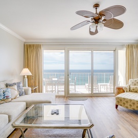 Relax in your bright living room with stunning ocean views. The coastal breeze from your ceiling fan complements the sea vista beyond.