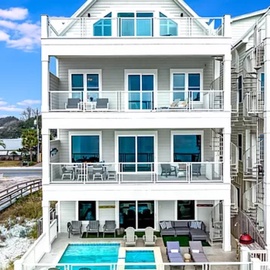 Modern beachfront retreat with private pool and multiple balconies overlooking pristine sandy shores.