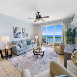 Unwind in your stylish living room where ocean breezes flow through open doors to your private balcony overlooking endless blue waters.